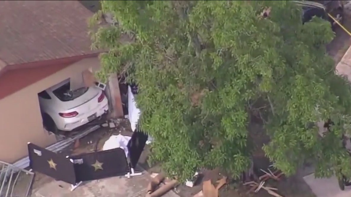 Car crashes into home, homicide investigation underway